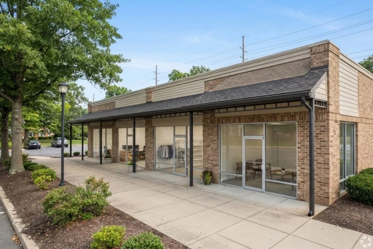 Brick office building with a covered walkway and glass storefront